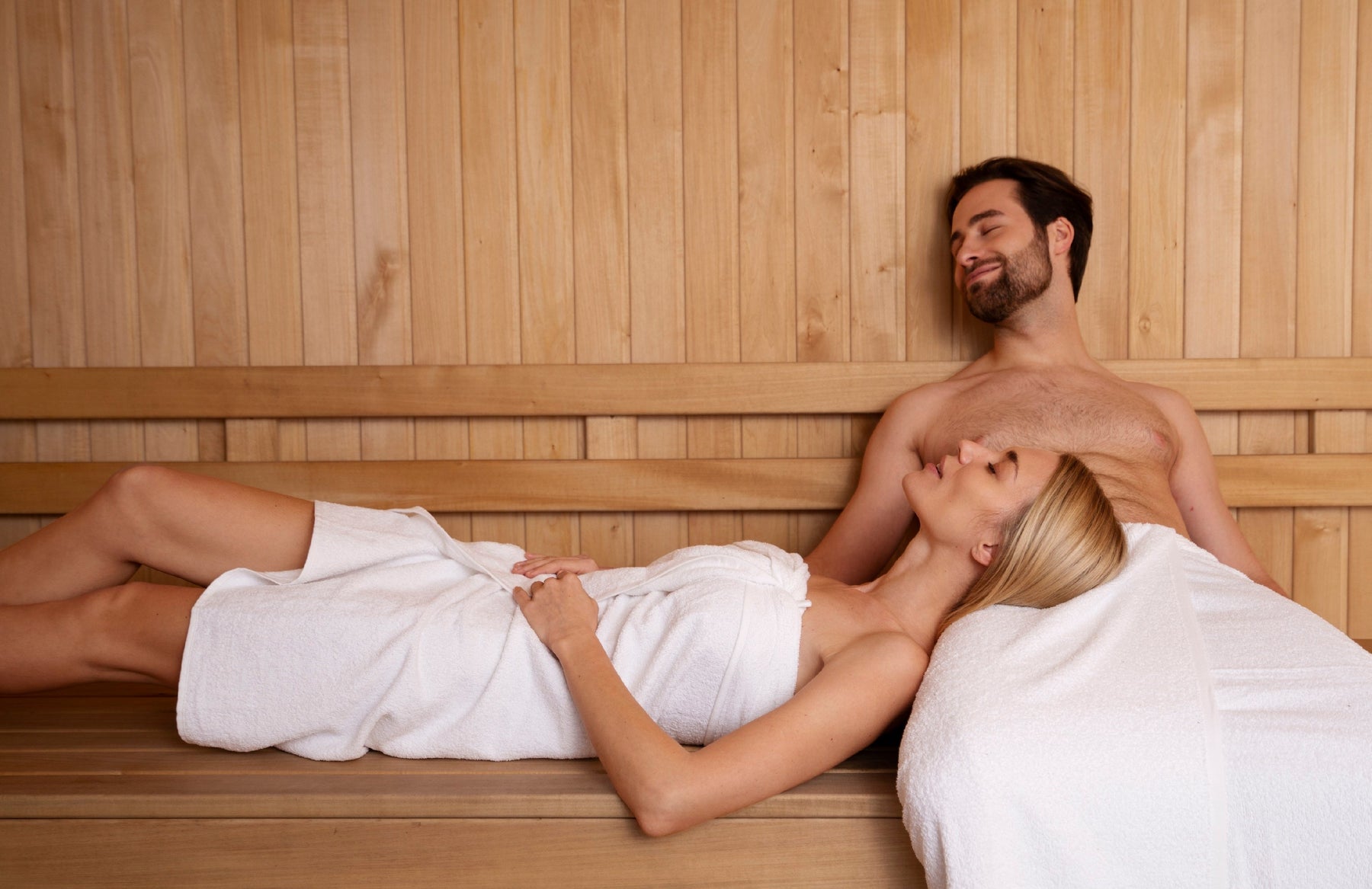 man and woman relaxing inside sauna